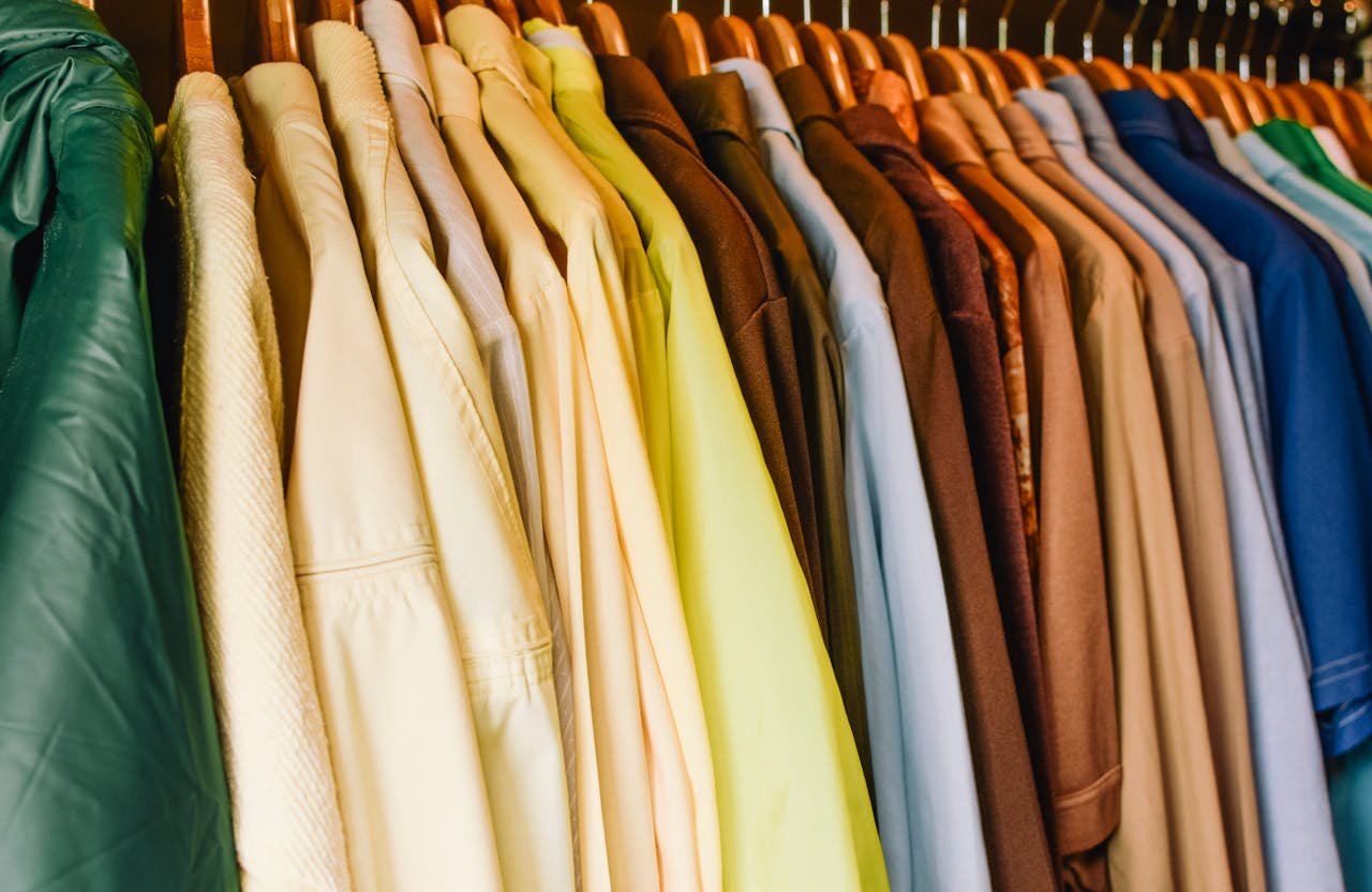 A vibrant selection of shirts and jackets in a wardrobe, perfect for fashion concepts.